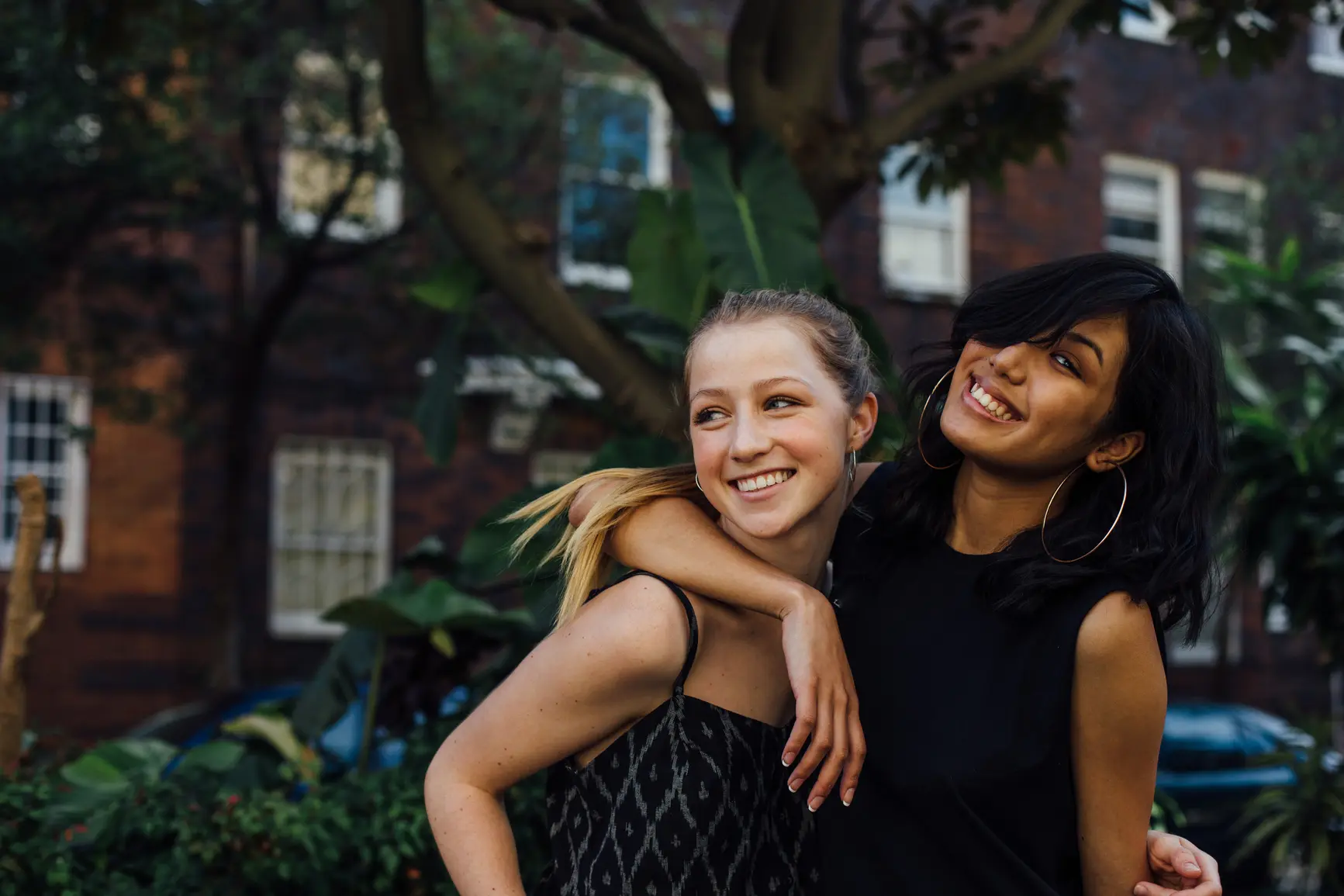 Child Psychologist - Kids, Tweens and Teens. Teenage girls looking happy outside an apartment block in Australia