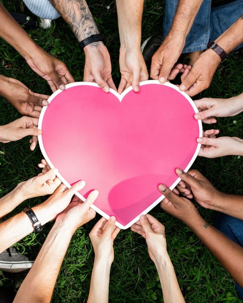 hands from all walks of life hold a heart - eofy appeal - donate before June 30 to make a real difference.