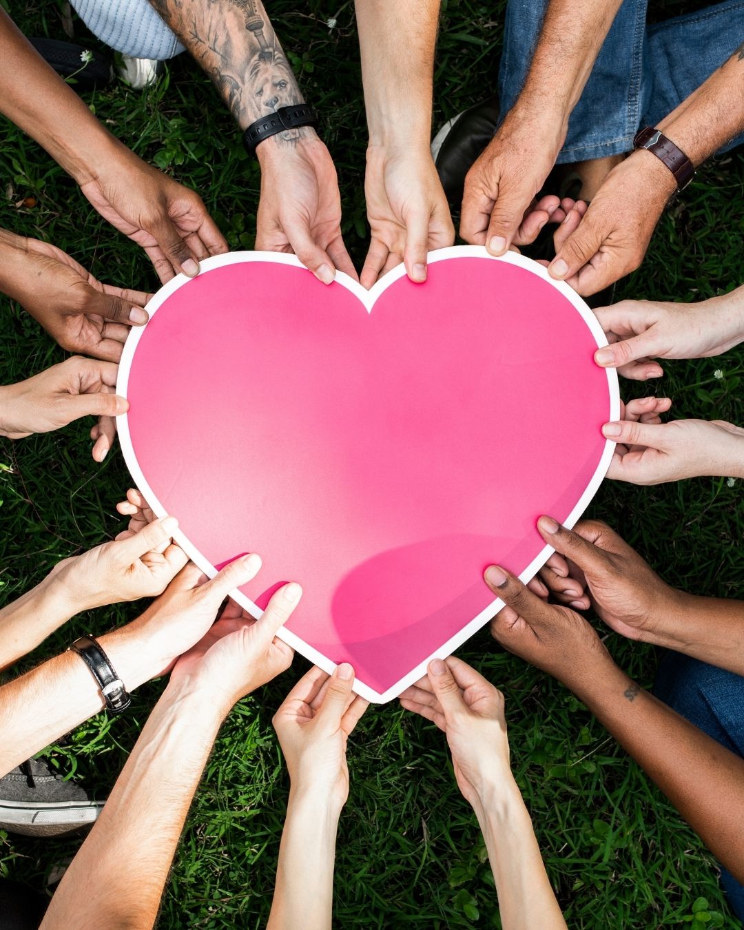 hands from all walks of life hold a heart - eofy appeal - donate before June 30 to make a real difference.